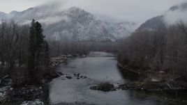 5.7K aerial stock footage of following the river toward snowy mountains in Leavenworth, Washington Aerial Stock Footage | DX0002_227_013
