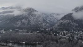 5.7K aerial stock footage a reverse view of Leavenworth and snowy mountains, Washington Aerial Stock Footage | DX0002_227_018
