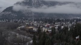 5.7K aerial stock footage focus on Leavenworth by snowy mountains, Washington during descent Aerial Stock Footage | DX0002_227_021