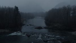 5.7K aerial stock footage reverse view of the river during light snowfall, Leavenworth, Washington Aerial Stock Footage | DX0002_227_027