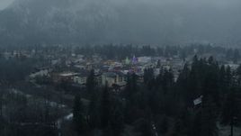 5.7K aerial stock footage of tall Christmas trees in the center of town while descending, Leavenworth, Washington Aerial Stock Footage | DX0002_227_032