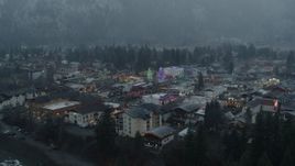 5.7K aerial stock footage of flying away from tall Christmas trees at the center of town, Leavenworth, Washington Aerial Stock Footage | DX0002_227_035