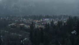 5.7K aerial stock footage of descending past tall Christmas trees at the center of town, Leavenworth, Washington Aerial Stock Footage | DX0002_227_036