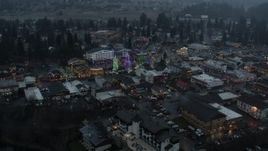 5.7K aerial stock footage ascend and orbit a small town while focused on Christmas trees and lights, Leavenworth, Washington Aerial Stock Footage | DX0002_227_046