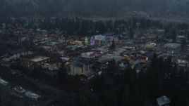 5.7K aerial stock footage orbit and fly away from a small town while focused on Christmas trees and lights, Leavenworth, Washington Aerial Stock Footage | DX0002_227_047