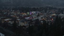 5.7K aerial stock footage fly away from a small town decorated with Christmas trees and lights, Leavenworth, Washington Aerial Stock Footage | DX0002_227_049