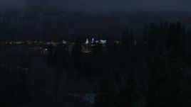 5.7K aerial stock footage focus on a small town with Christmas trees and lights at twilight during descent, Leavenworth, Washington Aerial Stock Footage | DX0002_228_005