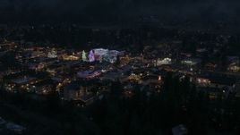 5.7K aerial stock footage of slowly approaching Christmas trees and lights at night in Leavenworth, Washington Aerial Stock Footage | DX0002_228_012