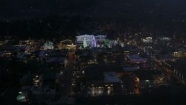 5.7K aerial stock footage slowly orbit town with Christmas trees and lights at night in Leavenworth, Washington Aerial Stock Footage | DX0002_228_015