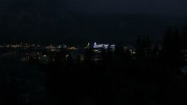5.7K aerial stock footage ascend to reveal and approach Christmas trees and lights at night in Leavenworth, Washington Aerial Stock Footage | DX0002_228_019