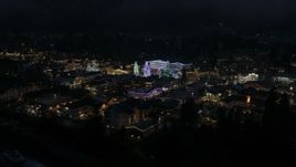 5.7K aerial stock footage reverse view of Christmas trees and lights at night, descend behind trees, Leavenworth, Washington Aerial Stock Footage | DX0002_228_020
