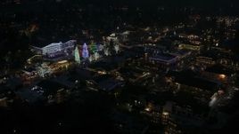 5.7K aerial stock footage orbiting trees and buildings with Christmas lights at night, Leavenworth, Washington Aerial Stock Footage | DX0002_228_025