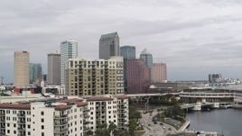 5.7K aerial stock footage fly away from tall skyscrapers, descend by apartments in Downtown Tampa, Florida Aerial Stock Footage | DX0003_229_004