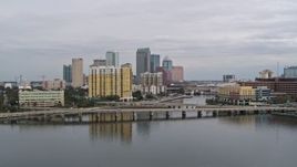 5.7K aerial stock footage the city skyline behind a condo complex and channel, Downtown Tampa, Florida Aerial Stock Footage | DX0003_229_037