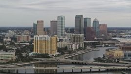 5.7K aerial stock footage of the skyline seen while passing bridges and channel, Downtown Tampa, Florida Aerial Stock Footage | DX0003_230_007