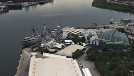 5.7K aerial stock footage of circling a warship museum and aquarium in Tampa, Florida Aerial Stock Footage | DX0003_230_033