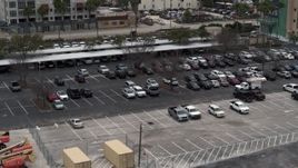 5.7K aerial stock footage of descending by a parking lot in Tampa, Florida Aerial Stock Footage | DX0003_230_035