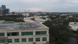 5.7K aerial stock footage ascend near office building to reveal freeway traffic in Tampa, Florida Aerial Stock Footage | DX0003_231_001