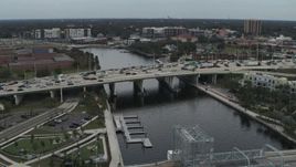 5.7K aerial stock footage orbit and approach traffic on a bridge spanning the river in Tampa, Florida Aerial Stock Footage | DX0003_231_029