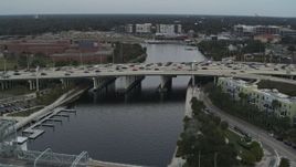 5.7K aerial stock footage fly away from traffic on a bridge spanning the river in Tampa, Florida Aerial Stock Footage | DX0003_231_030