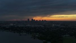 5.7K aerial stock footage reverse view of the distant city skyline of Downtown Tampa, Florida at sunset Aerial Stock Footage | DX0003_231_043
