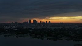 5.7K aerial stock footage ascend over McKay Bay while focused on the Downtown Tampa skyline at sunset, Florida Aerial Stock Footage | DX0003_231_047