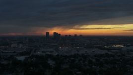 5.7K aerial stock footage a reverse view of the Downtown Tampa skyline at sunset, Florida Aerial Stock Footage | DX0003_231_048