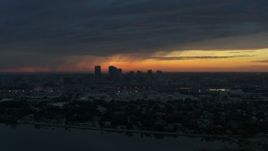 5.7K aerial stock footage a reverse view of the Downtown Tampa skyline from the bay at sunset, Florida Aerial Stock Footage | DX0003_231_049