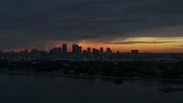 5.7K aerial stock footage ascending toward Downtown Tampa skyline from the bay at sunset, Florida Aerial Stock Footage | DX0003_231_054
