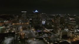 5.7K aerial stock footage of slowly flying away from skyscrapers at nighttime in Downtown Tampa, Florida Aerial Stock Footage | DX0003_232_035