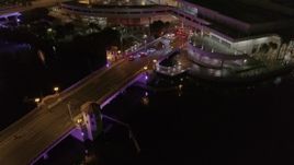 5.7K aerial stock footage orbit and fly away from police cars on the bridge by convention center at night in Downtown Tampa, Florida Aerial Stock Footage | DX0003_232_048
