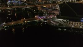 5.7K aerial stock footage approach police cars on the bridge by convention center at night in Downtown Tampa, Florida Aerial Stock Footage | DX0003_232_050