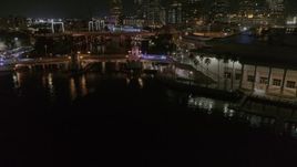 5.7K aerial stock footage fly away from police cars on a bridge by convention center at night in Downtown Tampa, Florida Aerial Stock Footage | DX0003_232_055