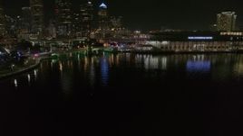 5.7K aerial stock footage descend while focused on police cars on a bridge by convention center at night in Downtown Tampa, Florida Aerial Stock Footage | DX0003_232_056