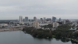 5.7K aerial stock footage of a wide view of the city's skyline, seen from a lake, Downtown Orlando, Florida Aerial Stock Footage | DX0003_233_004