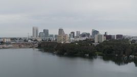5.7K aerial stock footage fly over lake toward the city's skyline, Downtown Orlando, Florida Aerial Stock Footage | DX0003_233_005