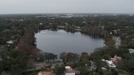 5.7K aerial stock footage of a reverse view of waterfront homes around Lake Adair, Orlando, Florida Aerial Stock Footage | DX0003_233_011
