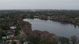 5.7K aerial stock footage of approaching waterfront homes around Lake Adair, Orlando, Florida Aerial Stock Footage | DX0003_233_012