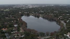 5.7K aerial stock footage ascend away from waterfront homes around Lake Adair, Orlando, Florida Aerial Stock Footage | DX0003_233_013