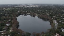 5.7K aerial stock footage of flying by waterfront homes around Lake Adair, Orlando, Florida Aerial Stock Footage | DX0003_233_014