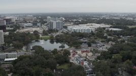 5.7K aerial stock footage of flying past Lake Dot and apartment buildings in Orlando, Florida Aerial Stock Footage | DX0003_233_018