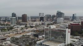 5.7K aerial stock footage fly away from city's skyline, reveal hotel, Downtown Orlando, Florida Aerial Stock Footage | DX0003_233_031