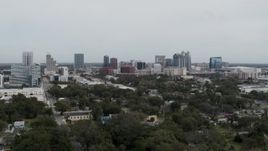 5.7K aerial stock footage ascending past the city's skyline, Downtown Orlando, Florida Aerial Stock Footage | DX0003_233_049