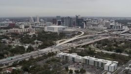 5.7K aerial stock footage stationary view of Amway Center, city skyline, and freeway interchange, Downtown Orlando, Florida Aerial Stock Footage | DX0003_234_002