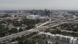 5.7K aerial stock footage of Amway Center, city skyline beside freeway interchange, Downtown Orlando, Florida Aerial Stock Footage | DX0003_234_003
