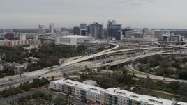 5.7K aerial stock footage reverse view of Amway Center, city skyline, freeway interchange, Downtown Orlando, Florida Aerial Stock Footage | DX0003_234_006