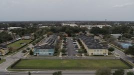 5.7K aerial stock footage ascend away from an apartment complex in Orlando, Florida Aerial Stock Footage | DX0003_234_011