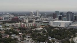 5.7K aerial stock footage of flying by apartment complex, Amway Center and city skyline, Downtown Orlando, Florida Aerial Stock Footage | DX0003_234_021