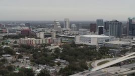 5.7K aerial stock footage descend by apartment complex, Amway Center and city skyline, Downtown Orlando, Florida Aerial Stock Footage | DX0003_234_022