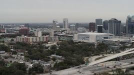 5.7K aerial stock footage slowly passing apartment complex, Amway Center and city skyline, Downtown Orlando, Florida Aerial Stock Footage | DX0003_234_023